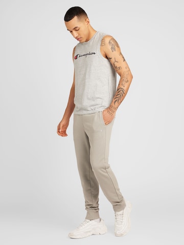 Champion Authentic Athletic Apparel Tapered Housut 'Legacy' värissä harmaa