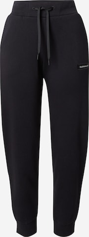Effilé Pantalon de sport PEAK PERFORMANCE en noir : devant