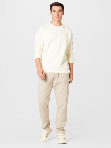 Kosta Williams x About You Regular Trousers in Beige