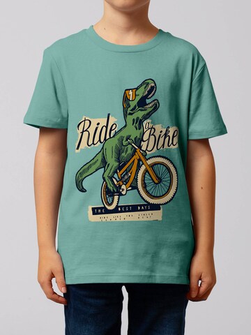 watabout.kids Shirt 'T-Rex Fahrrad' in Blauw: voorkant