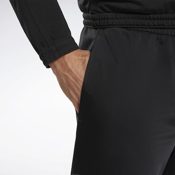 Reebok Ozke Športne hlače | črna barva