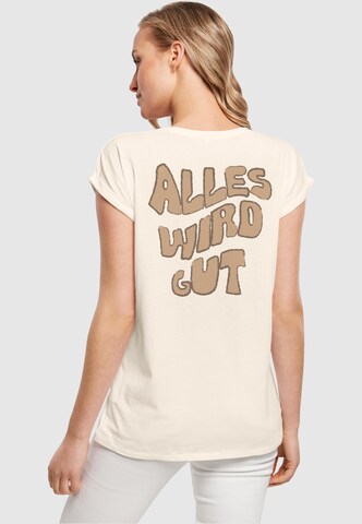 Merchcode Shirt 'Alles Wird Gut' in Beige: voorkant