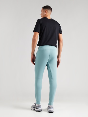 Effilé Pantalon 'TCH FLC' Nike Sportswear en vert