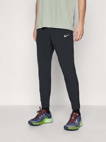 NIKE Tapered Workout Pants 'STRIDE' in Black: front