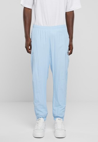 Karl Kani Tapered Pants in Blue: front