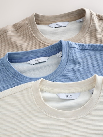 Tricou de la Next pe bej
