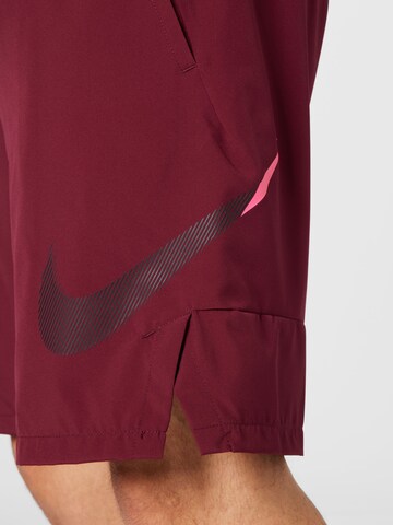 Loosefit Pantalon de sport NIKE en rouge