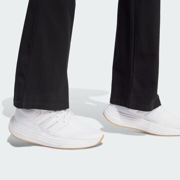 Flared Pantaloni sportivi 'Essentials' di ADIDAS SPORTSWEAR in nero