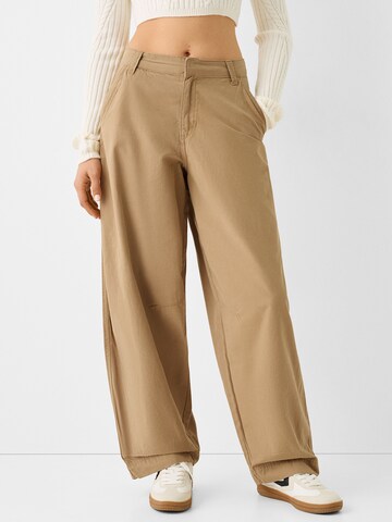 Bershka Loose fit Chino trousers in Beige: front