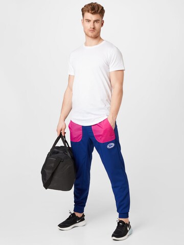 NIKE - Tapered Pantalón deportivo en azul