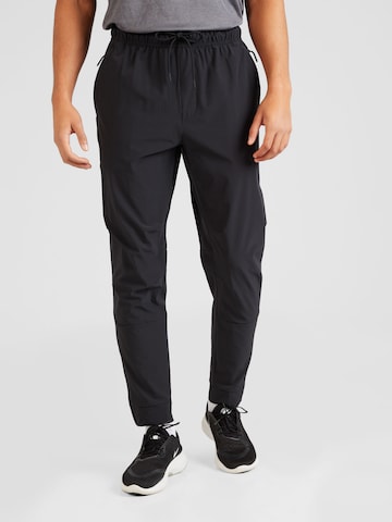 Effilé Pantalon de sport 'Unlimited' NIKE en noir : devant