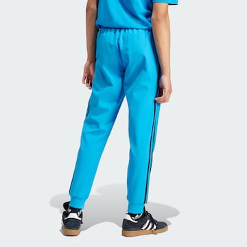 ADIDAS ORIGINALS Zwężany krój Spodnie 'SST Bonded' w kolorze niebieski