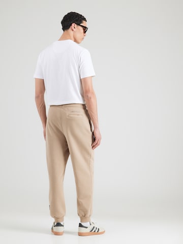 Tapered Pantaloni de la Carlo Colucci pe maro: spate