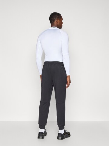 NIKE Tapered Sportnadrágok 'FLEX' - fekete