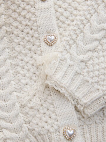 Next Neuletakki värissä beige