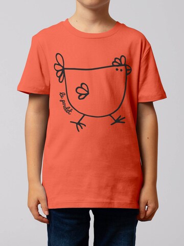 watabout.kids Shirt 'Le Poulet - Das Huhn' in Oranje: voorkant