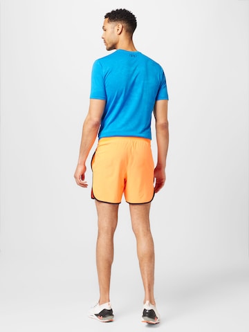 Regular Pantalon de sport UNDER ARMOUR en orange