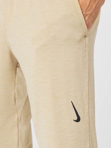 NIKE Tapered Workout Pants in Beige