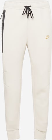 Tapered Pantaloni 'TCH FLEECE' di Nike Sportswear in beige: frontale