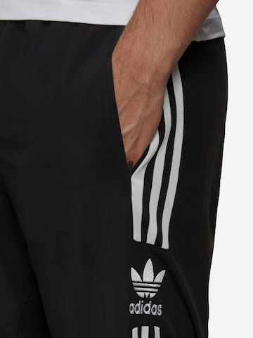 juoda ADIDAS ORIGINALS Siaurėjantis Kelnės