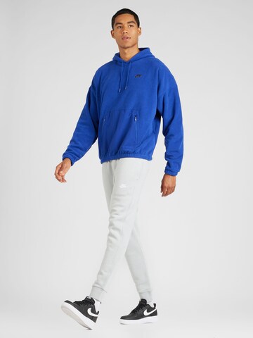 Nike Sportswear Tapered Housut 'Club Fleece' värissä valkoinen