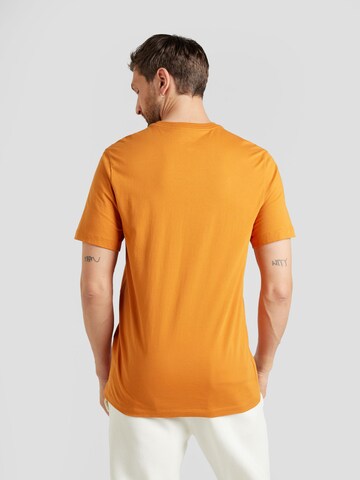T-Shirt 'SWOOSH' Nike Sportswear en orange