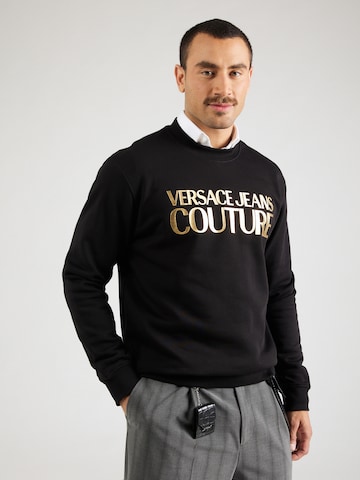 Versace Jeans CoutureSweater majica - crna boja: prednji dio