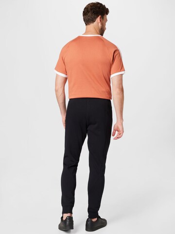 Tapered Pantaloni sport de la ADIDAS SPORTSWEAR pe negru