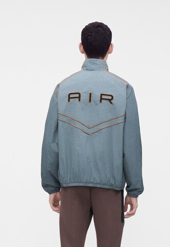 Nike Sportswear Övergångsjacka 'AIR' i grå: framsida