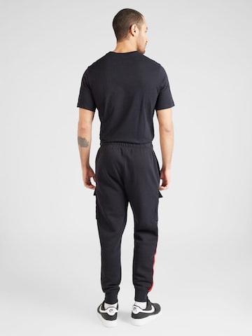 Tapered Pantaloni cu buzunare 'AIR' de la Nike Sportswear pe negru