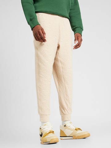 Effilé Pantalon de sport NIKE en beige : devant