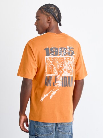 Tricou 'BRK' de la Jordan pe portocaliu: față