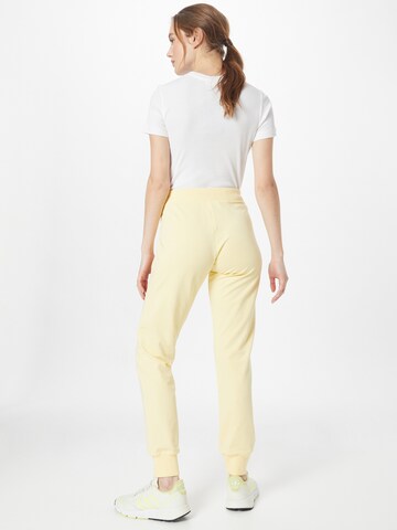 Tapered Pantaloni di Champion Authentic Athletic Apparel in giallo