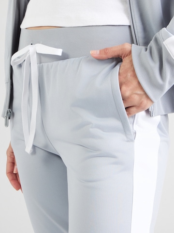 UNDER ARMOUR Skinny Športna trenirka | siva barva