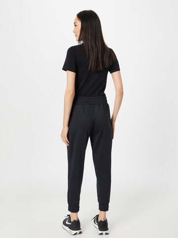 UNDER ARMOUR Tapered Sports trousers 'Meridian' in Black