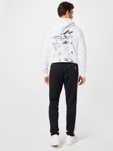 UNDER ARMOUR Tapered Sportbroek in Zwart