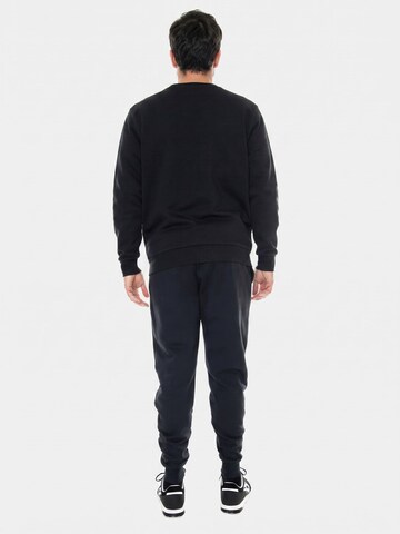 Baggy Pantalon 'UA Rival Fleece Joggers Black' UNDER ARMOUR en noir