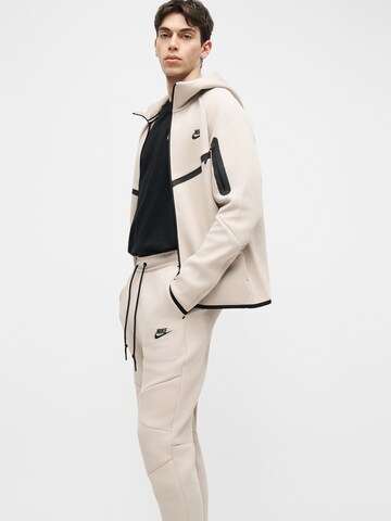 Nike Sportswear Zwężany krój Spodnie 'Tech Fleece' w kolorze beżowy