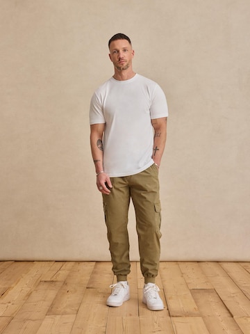 DAN FOX APPAREL Tapered Trousers 'Mats' in Green: front