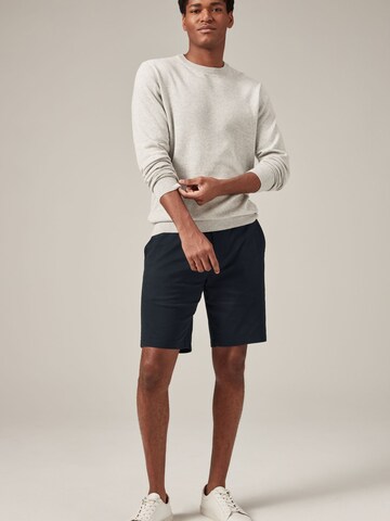 Next Slimfit Chinohousut värissä sininen