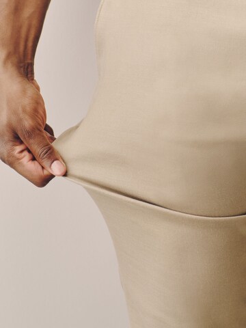 Coupe slim Pantalon à plis 'Motionflex' Next en gris