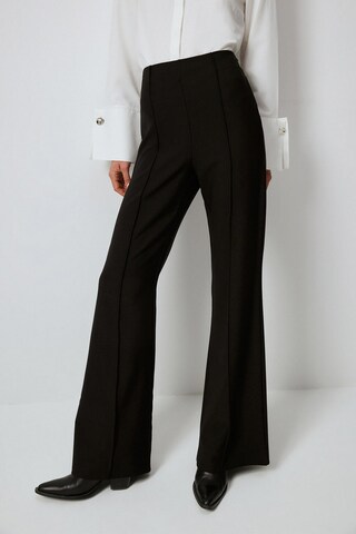 Touche Prive Flared Trousers in Black: front
