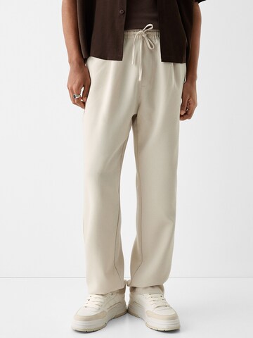 Bershka Loose fit Pleat-Front Pants in Beige: front