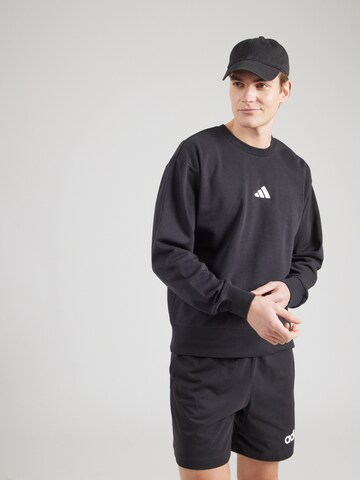 ADIDAS SPORTSWEAR Спортивный свитшот 'FEELCOZY' в Черный: спереди