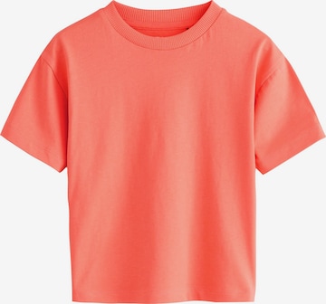 Next T-shirt i orange: framsida