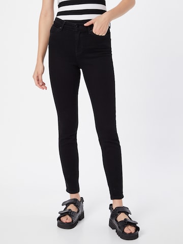 Skinny Jeans de la GUESS pe negru: față