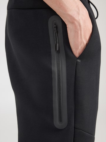 Nike Sportswear Loosefit Housut 'TECH FLC' värissä musta