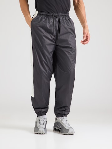 Nike Sportswear Tapered Pants in Black: front