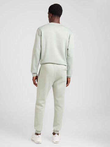 Tapered Pantaloni 'CLUB FLEECE' de la Nike Sportswear pe verde