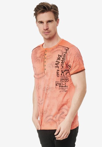 Rusty Neal T-Shirt mit lässigem Allover-Print in Orange: predná strana